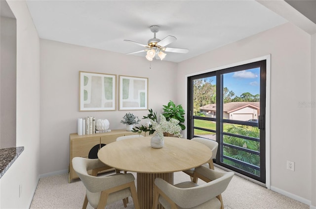 dining area featuring a ceiling fan, baseboards, and carpet floors