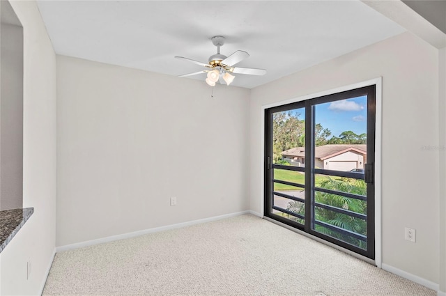 carpeted empty room with baseboards and ceiling fan