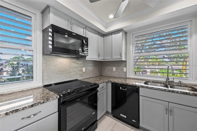 kitchen with black appliances, a sink, dark stone countertops, backsplash, and crown molding