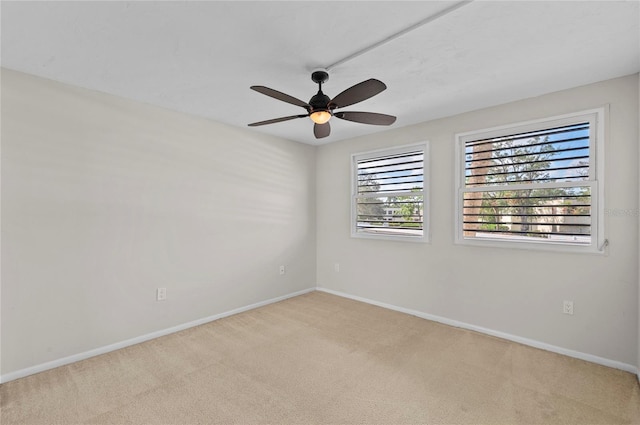 empty room with baseboards, a ceiling fan, and carpet flooring