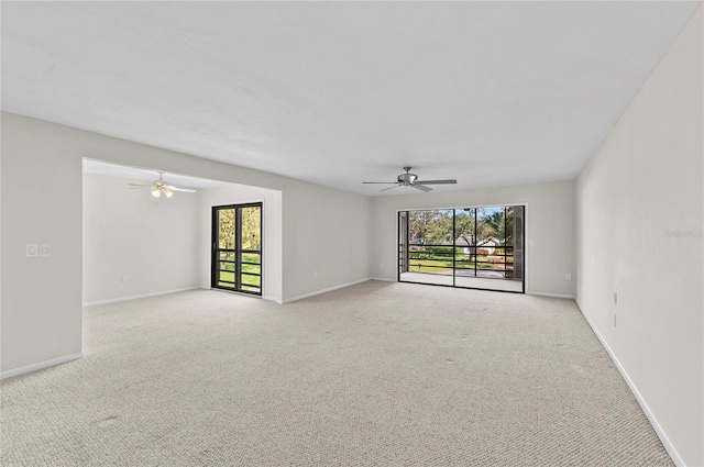 unfurnished room with baseboards, carpet, and a ceiling fan