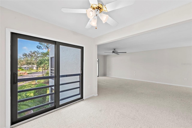 spare room with ceiling fan, baseboards, and carpet