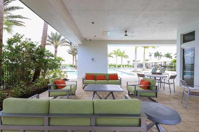 view of patio with an outdoor hangout area, a community pool, and ceiling fan