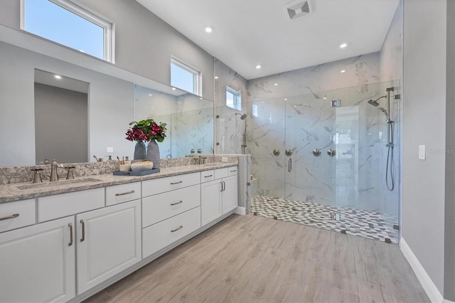 bathroom featuring a shower with door, vanity, and hardwood / wood-style floors