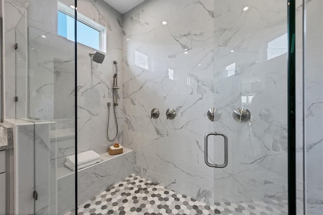 bathroom featuring a shower with shower door