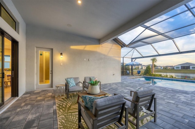 view of patio / terrace featuring a lanai, outdoor lounge area, and a water view