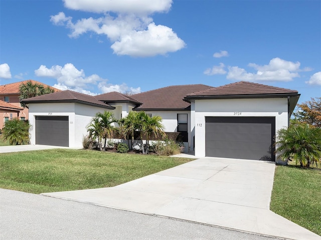 view of front of house featuring a garage and a front lawn