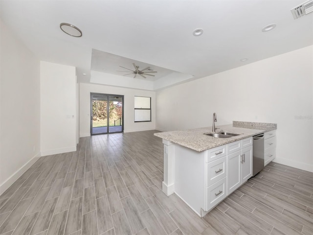 kitchen with sink, white cabinetry, light hardwood / wood-style flooring, and dishwasher