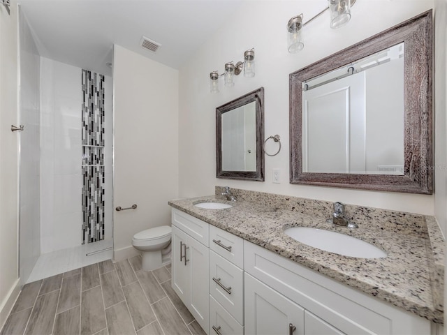 bathroom with toilet, walk in shower, and vanity