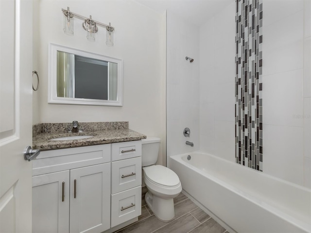 full bathroom with vanity, toilet, and tiled shower / bath combo