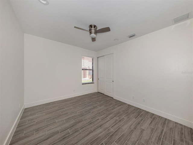 empty room featuring hardwood / wood-style floors and ceiling fan