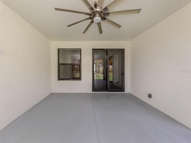 view of exterior entry with a patio and ceiling fan