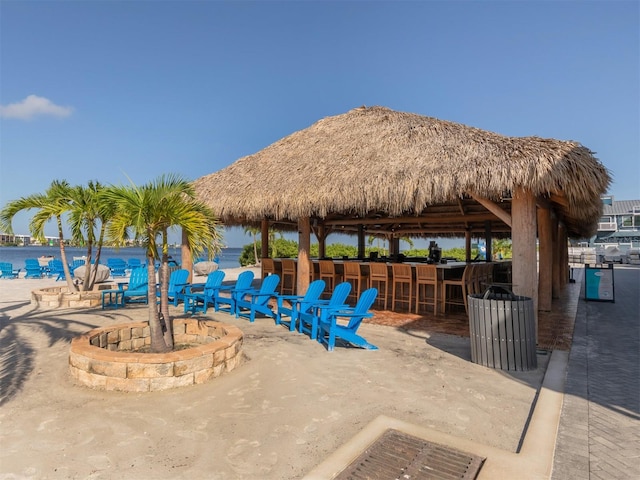 view of patio / terrace featuring a water view, a gazebo, and an outdoor bar