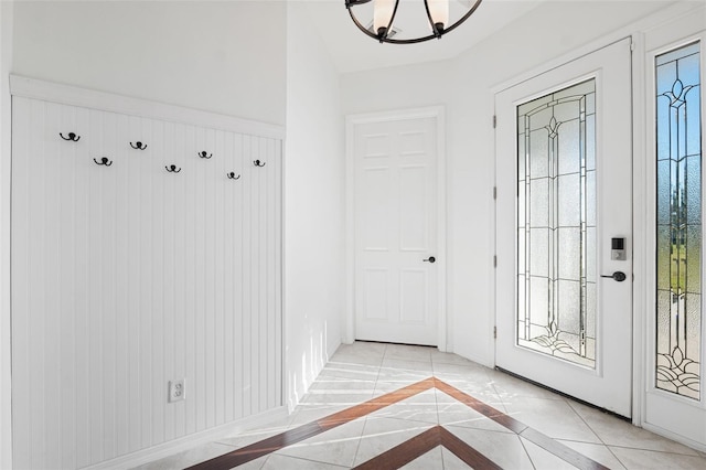 mudroom featuring light tile patterned floors and a chandelier