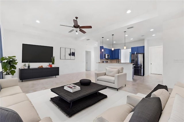 tiled living room with ceiling fan