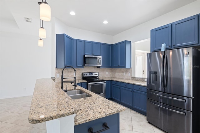 kitchen with decorative backsplash, stainless steel appliances, sink, blue cabinetry, and hanging light fixtures