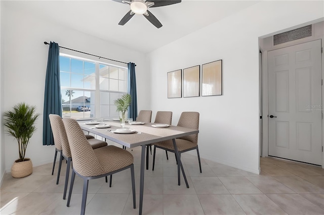 tiled dining space with ceiling fan