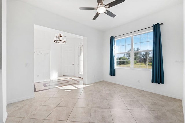 foyer with ceiling fan with notable chandelier and light tile patterned floors