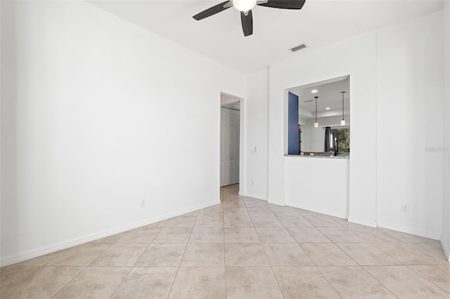 unfurnished room with ceiling fan and light tile patterned floors