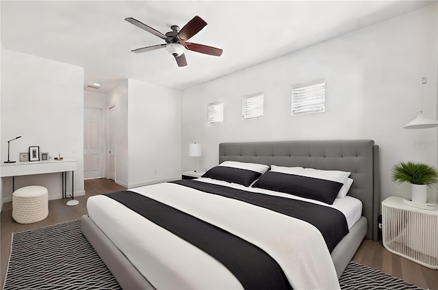 bedroom featuring ceiling fan and dark hardwood / wood-style floors