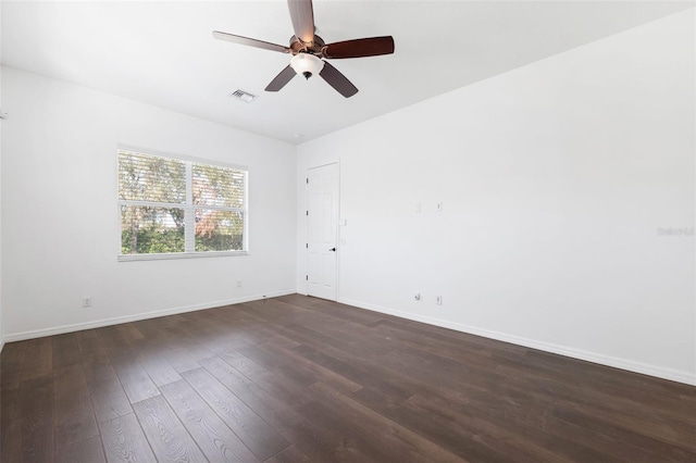 empty room with dark hardwood / wood-style flooring and ceiling fan