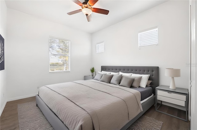 bedroom with dark hardwood / wood-style floors and ceiling fan