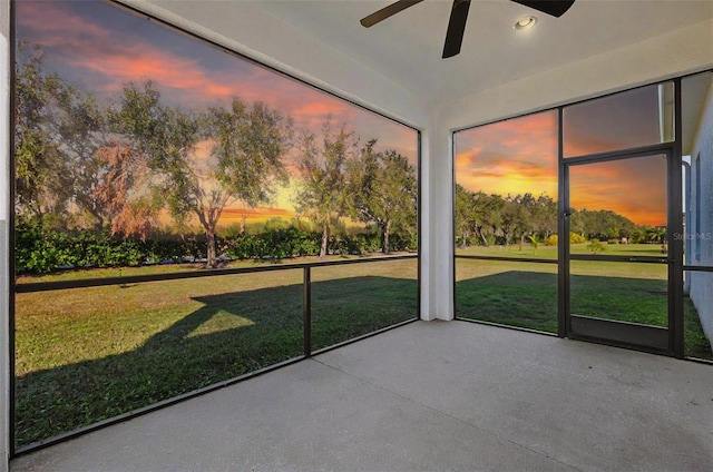 unfurnished sunroom featuring ceiling fan