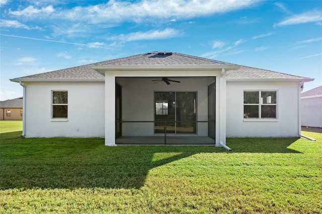 back of property with a sunroom and a yard