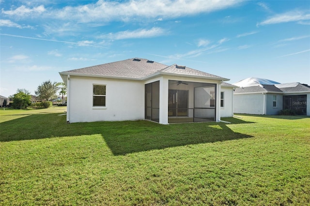 back of house with a lawn and a sunroom