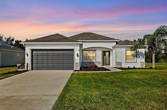 single story home with a garage, driveway, stone siding, stucco siding, and a front yard