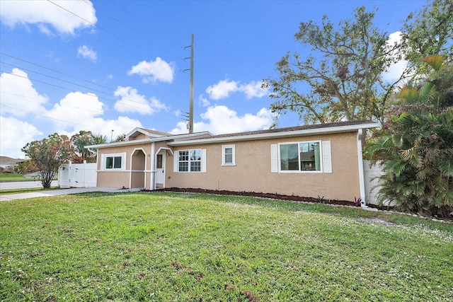 single story home with stucco siding, a front lawn, and fence