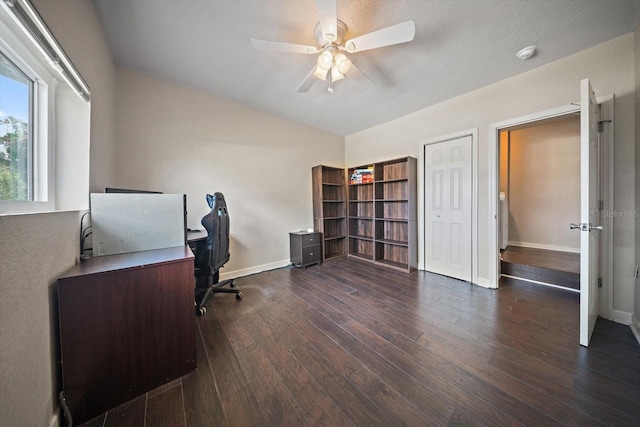 home office featuring dark wood-type flooring and ceiling fan