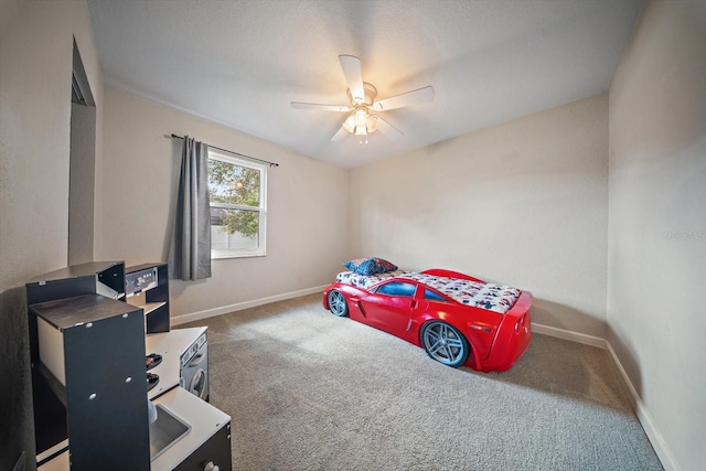 bedroom featuring ceiling fan and dark carpet