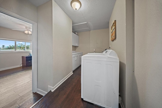 laundry room with separate washer and dryer, a textured ceiling, dark wood-type flooring, cabinets, and ceiling fan