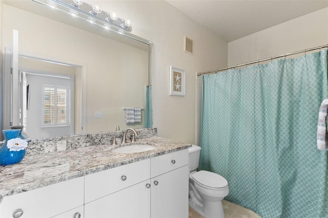 bathroom with toilet, vanity, and a shower with shower curtain