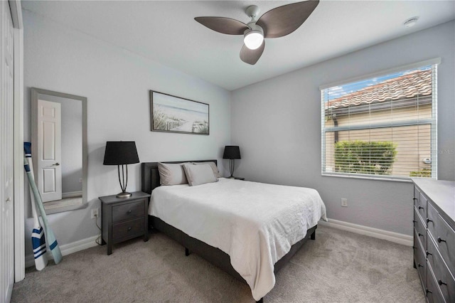 bedroom featuring ceiling fan and light colored carpet