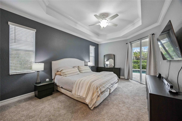 bedroom featuring access to outside, a raised ceiling, ceiling fan, and light colored carpet