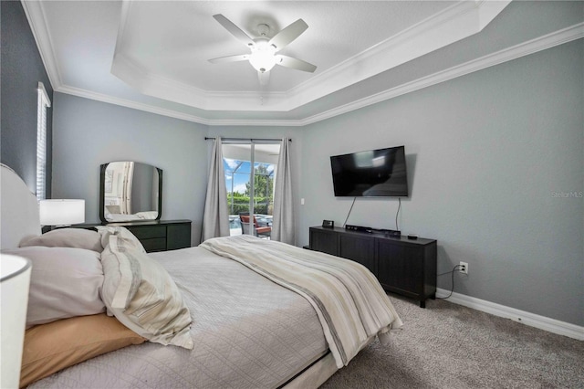 carpeted bedroom with ceiling fan, access to exterior, ornamental molding, and a tray ceiling