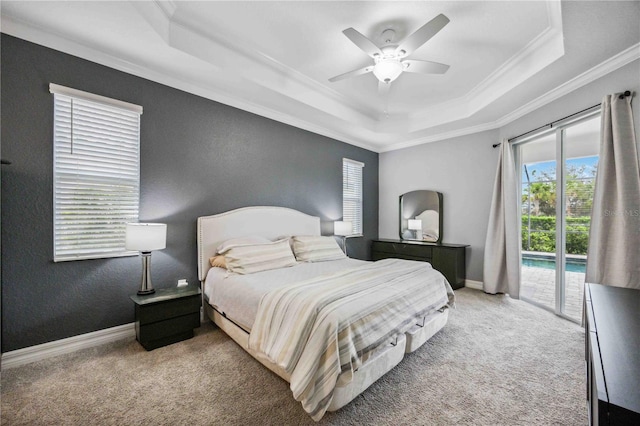 bedroom featuring access to exterior, a tray ceiling, ceiling fan, and light colored carpet