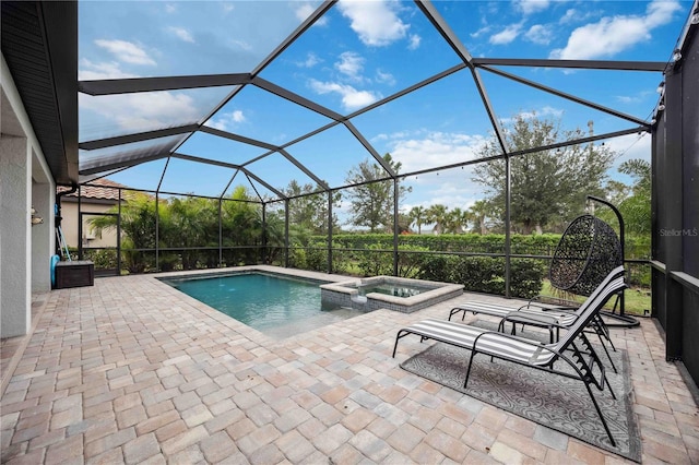 view of swimming pool with an in ground hot tub, a patio, and a lanai