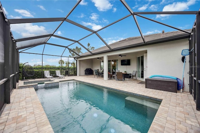 view of pool with an in ground hot tub, a lanai, a patio area, and ceiling fan