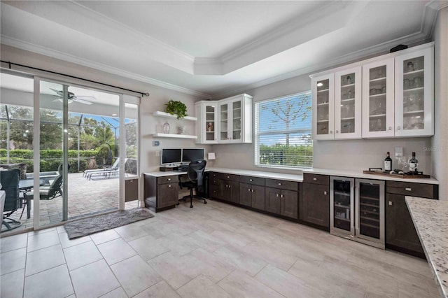 office with a raised ceiling, bar area, beverage cooler, and ornamental molding