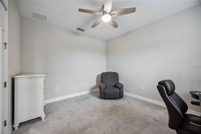 office space with light carpet and ceiling fan