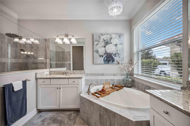 bathroom with tile patterned floors, ornamental molding, vanity, an inviting chandelier, and independent shower and bath