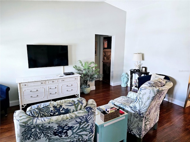 living room featuring dark hardwood / wood-style floors and vaulted ceiling