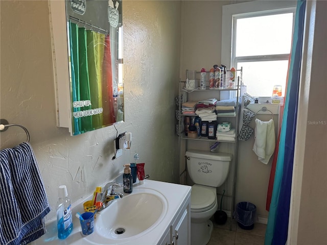 bathroom featuring vanity, toilet, and tile patterned floors