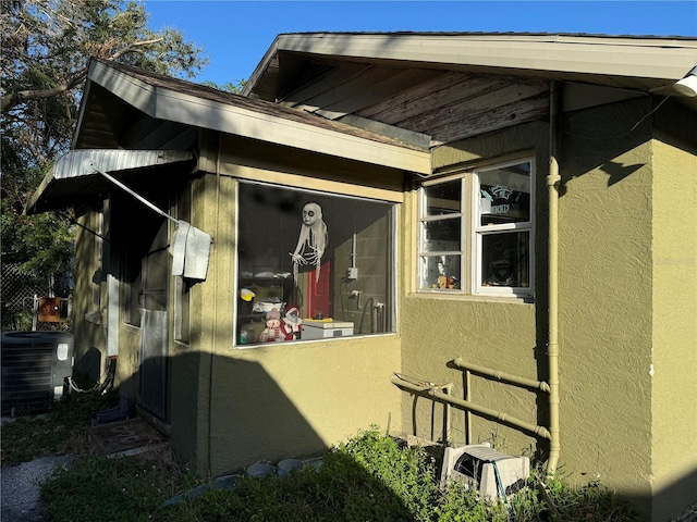 view of side of home with cooling unit