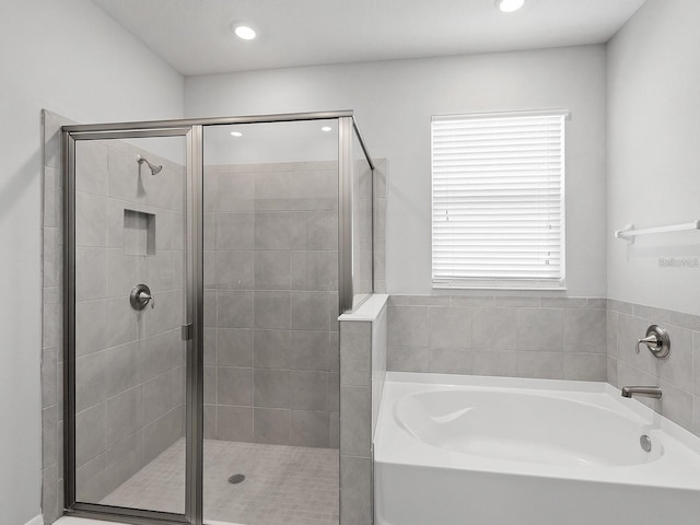 bathroom with shower with separate bathtub