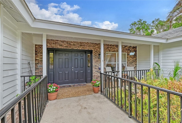 doorway to property featuring covered porch