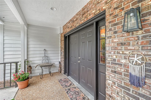 view of exterior entry with covered porch